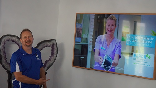 Technician - Jason with a TV he hung in a customers living room