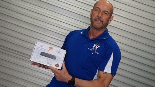Technician holding up a vast decoder box