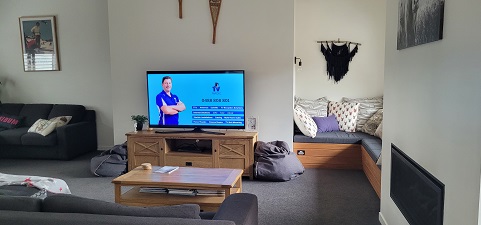 Screen in a living room - Technician Sam on the screen 