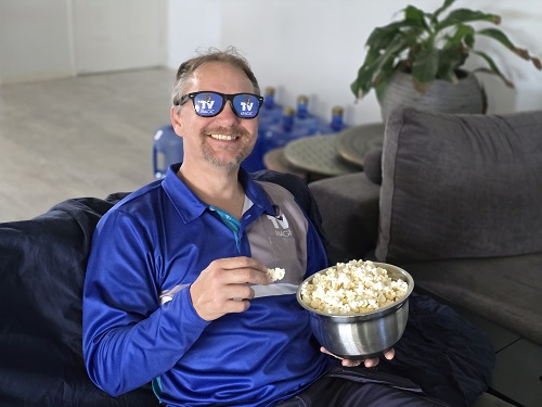 Technician eating popcorn, wearing TV Magic sunglasses