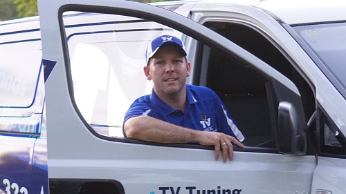 Technician - Matt, leaning on his van door