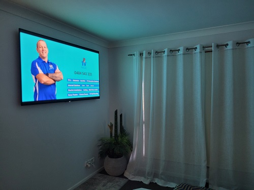 Wall mounted TV, showing technician and his services