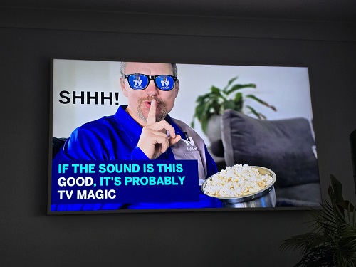 Technician eating popcorn. Caption below - "If the sound is this good it's probably TV Magic"