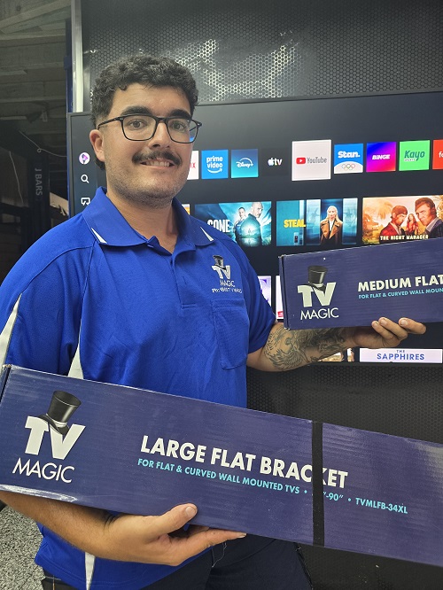 Technician holding TV Magic wall mounting bracket