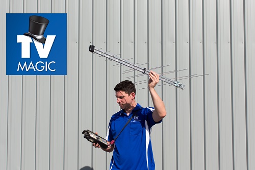 technician - Sam, holding up an antenna testing signal