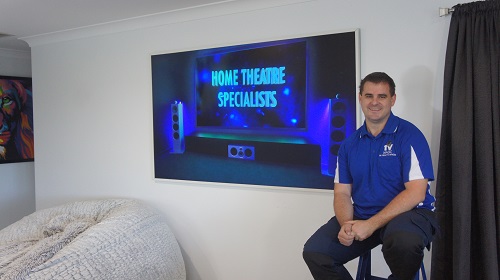 Technician in front of a large TV