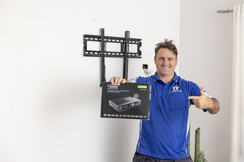 Technician holding up a vast decoder box.