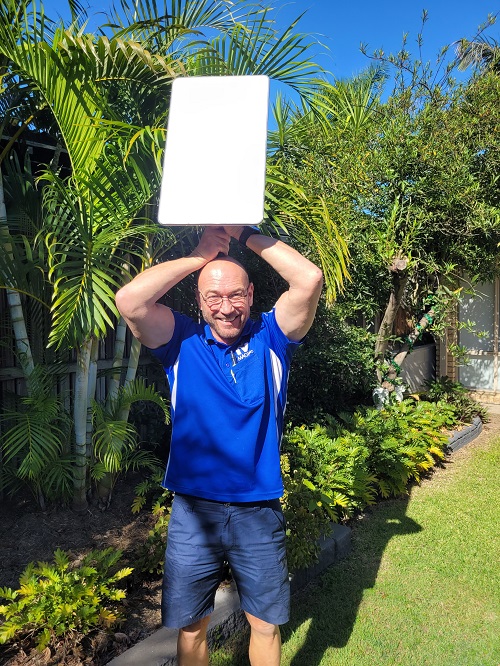 Technician holding a Starlink dish above his head
