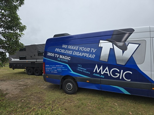 TV Magic big van next to a caravan.