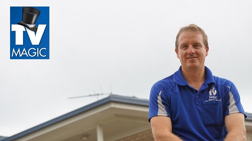 a technician in front of a home, with a TV Magic logo in top left corner
