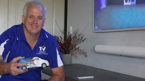 Technician - Steve, holding a mini TV Magic van