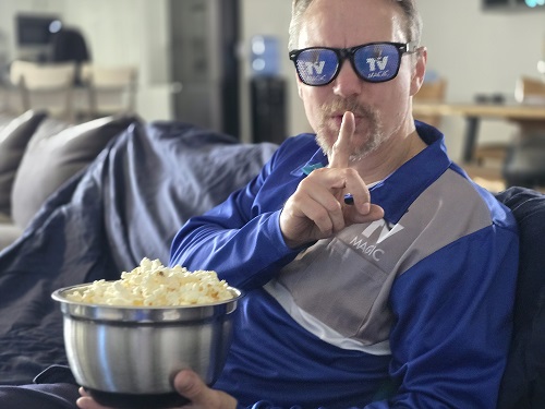 Technician going "shhhhh" with bowl of popcorn