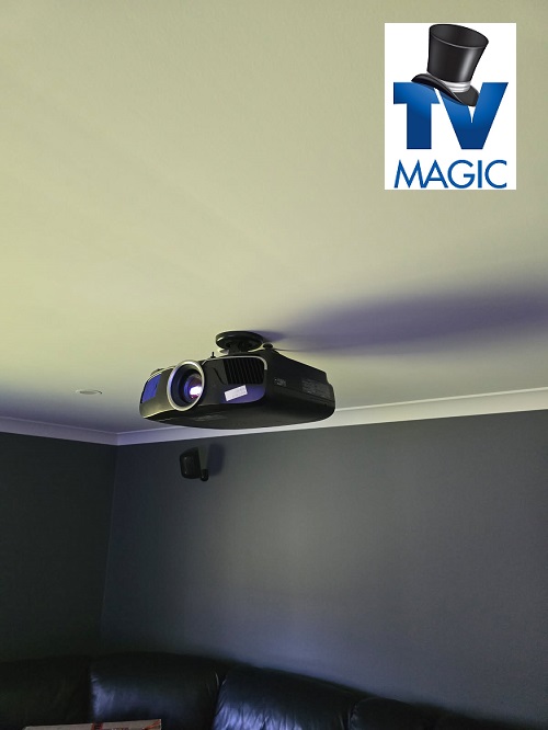Ceiling mounted projector with TV Magic logo in top right corner