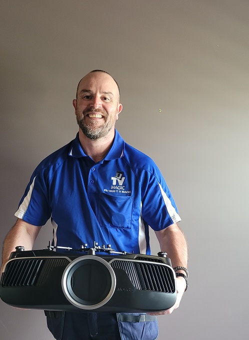 Technician holding a large projector