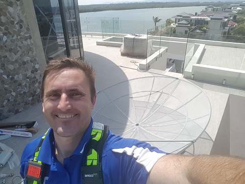 Technician with a large satellite dish