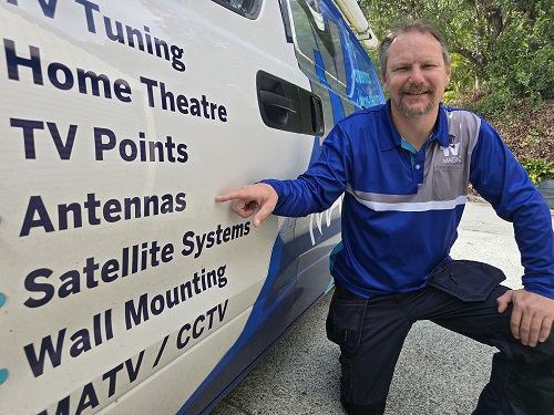 Technician pointing to antenna services on van