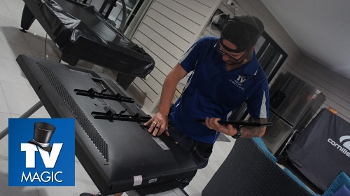 Technician assessing a damaged TV