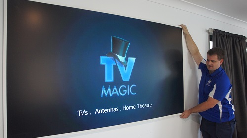 Technician mounting a TV