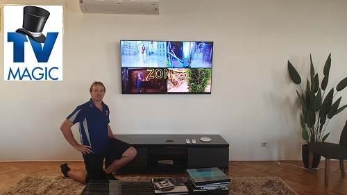 Technician Brent - with a newly wall mounted TV. TV Magic logo in top left corner