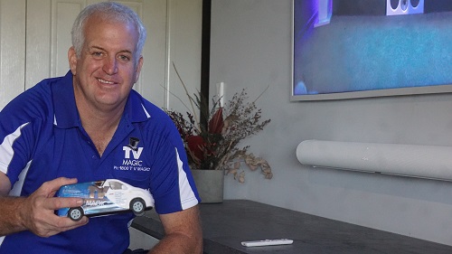 Technician - Steve, holding a mini TV Magic van