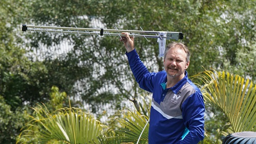 Technician holding up an aerial