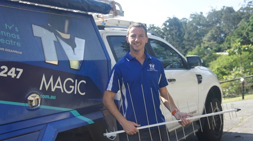 Jim next to his TV Magic van, holding an antenna