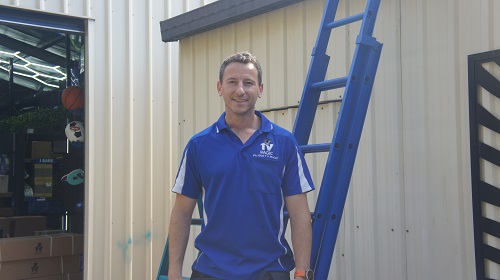 Technician Jim, standing next to a ladder.