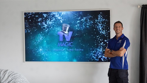 Jim with a giant wall mounted TV