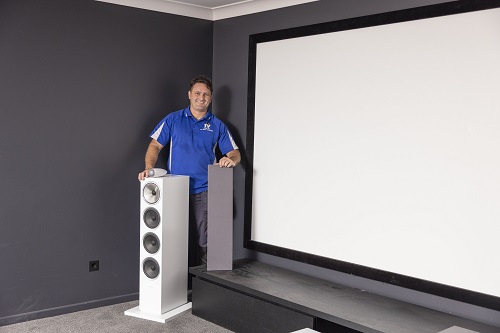 Technician standing in a home cinema he installed