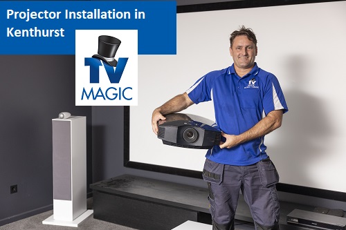 Technician holding a projector in a customers home cinema he designed.