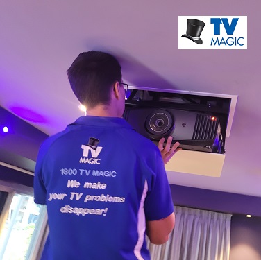 a technician installing a new projector lamp