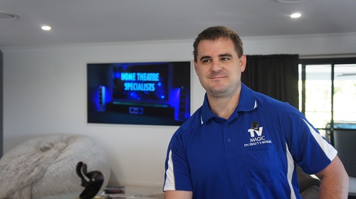 Technician in front of a large TV