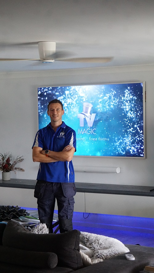 TV Magic technician in front of a freshly wall mounted TV