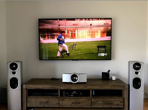 a complete TV setup with speakers - wall mounted TV