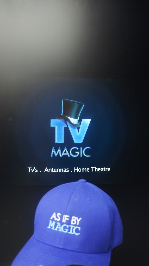 A vertical TV screen with a TV Magic cap in front that says "As if by Magic"