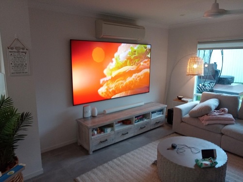 a wall mounted TV in a living room