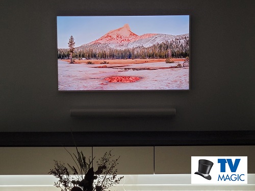 samsung frame TV mounted on a wall with a TV Magic logo in bottom right corner