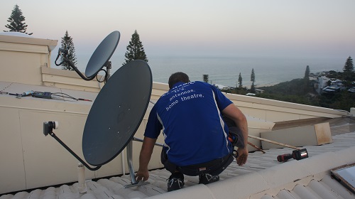 Technician installing a satellite dish