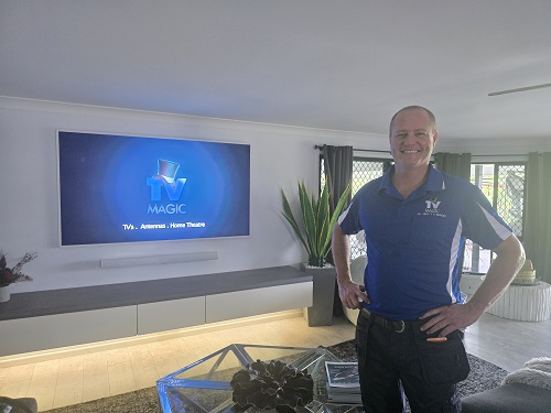 Technician with a TV and soundbar he installed