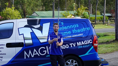 Technician - Gordon, next to his van, holding an antenna