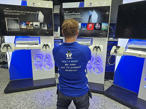 Technician in front of a commercial gaming console setup he attended to.