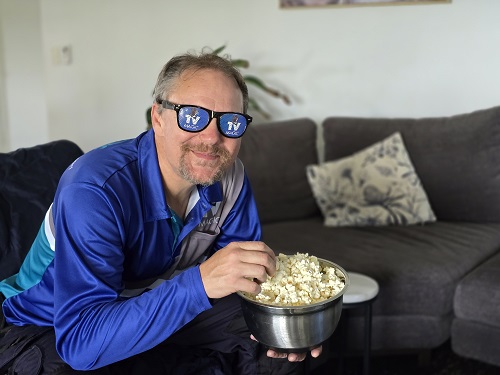 TV Magic tech in home cinema eating popcorn