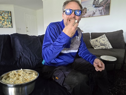 Technician eating popcorn, wearing TV Magic sunglasses