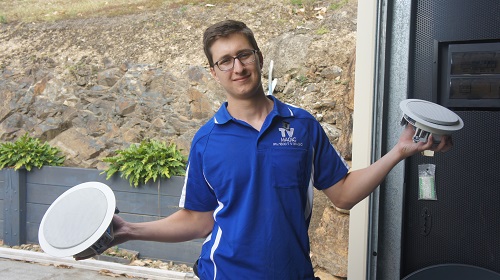 Technician with speakers in both hands
