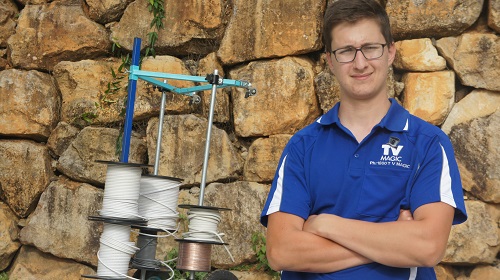 Technician standing near rolls of cabling