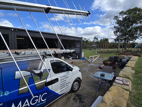 TV Magic van with antenna in front of it