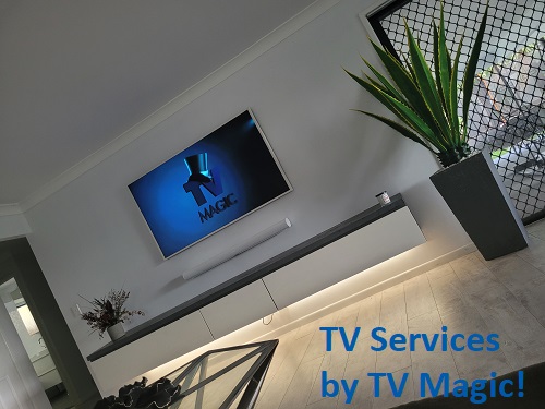 an angled picture of a complete wall mounted TV setup. Caption in bottom right corner "TV Services by TV Magic!"