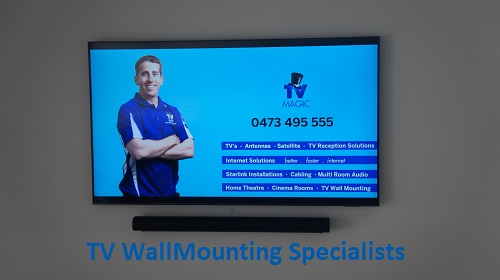 a wall mounted TV with technician - Gordon on screen with his services