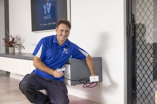Technician holding a TV point ready for installation